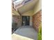 Inviting front entryway with brick accents and a covered porch at 11323 E Cimmarron Dr, Englewood, CO 80111