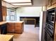 Functional kitchen with wood cabinets and adjacent dining area with railing to basement at 11323 E Cimmarron Dr, Englewood, CO 80111