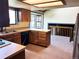 The kitchen with adjacent eat-in area features wood cabinets, beige countertops, and lots of natural light at 11323 E Cimmarron Dr, Englewood, CO 80111