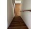 Staircase with carpeted steps and a wooden handrail at 11323 E Cimmarron Dr, Englewood, CO 80111