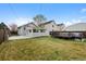 Spacious backyard featuring green grass and patio area, perfect for outdoor entertaining at 3057 S Fox St, Englewood, CO 80110
