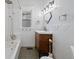 Bathroom featuring new fixtures, sleek modern vanity and shower-tub combo with tiled surround at 3057 S Fox St, Englewood, CO 80110