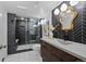Nicely renovated bathroom featuring a black and white herringbone accent wall, concrete vanity and shower at 3057 S Fox St, Englewood, CO 80110