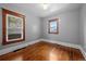 Bright bedroom showcasing hardwood floors and two windows with outside views at 3057 S Fox St, Englewood, CO 80110