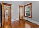 Bright bedroom featuring hardwood floors and doorway to the next room at 3057 S Fox St, Englewood, CO 80110