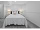Neutral bedroom with a plush bed, bedside tables, and wainscoting at 3057 S Fox St, Englewood, CO 80110