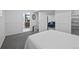 Bedroom with en-suite bathroom and view into the living room space at 3057 S Fox St, Englewood, CO 80110