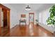Spacious dining room featuring hardwood floors, stylish console table and views into the kitchen at 3057 S Fox St, Englewood, CO 80110