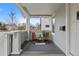 Inviting front porch with seating area, stylish decor, privacy and view of the front yard at 3057 S Fox St, Englewood, CO 80110