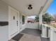 Charming front porch with modern light fixture, white railings, and view of the neighborhood at 3057 S Fox St, Englewood, CO 80110