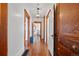 Hallway with hardwood floors and wooden trim leading to a bedroom and featuring an antique cabinet at 3057 S Fox St, Englewood, CO 80110