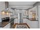 Kitchen showcasing stainless steel appliances, modern cabinets, subway tile backsplash, and hardwood floors at 3057 S Fox St, Englewood, CO 80110