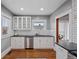 Bright kitchen features white cabinets, stainless steel appliances, and a subway tile backsplash at 3057 S Fox St, Englewood, CO 80110