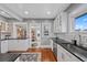 Modern kitchen with stainless steel appliances, white cabinets, and an undermount sink at 3057 S Fox St, Englewood, CO 80110