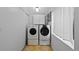 Functional laundry room featuring a washer and dryer and overhead cabinets for ample storage at 3057 S Fox St, Englewood, CO 80110