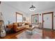 Stylish living room featuring a comfortable leather sofa, hardwood floors, and modern decor at 3057 S Fox St, Englewood, CO 80110