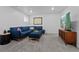 Cozy living room with a comfortable blue sofa and entertainment center at 3057 S Fox St, Englewood, CO 80110