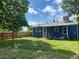 A view of the backyard and house, featuring a well maintained lawn and fence line at 1701 W 50Th Ave, Denver, CO 80221