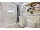 Modern bathroom with subway tile, updated fixtures, and a shower-tub combination, creating a clean and stylish space at 1701 W 50Th Ave, Denver, CO 80221