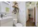Stylish bathroom featuring subway tile, floating wooden shelves, and modern fixtures, creating a spa-like ambiance at 1701 W 50Th Ave, Denver, CO 80221