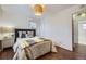 Comfortable bedroom with hardwood floors, neutral colors, and natural light from the window at 1701 W 50Th Ave, Denver, CO 80221