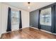 Well-lit bedroom with hardwood floors, large windows with coverings, and neutral wall colors at 1701 W 50Th Ave, Denver, CO 80221