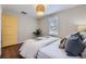 Bright bedroom with hardwood floors, neutral colors, and natural light from the window at 1701 W 50Th Ave, Denver, CO 80221