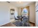 Charming dining room featuring a round table, stylish chairs, hardwood floors, and view to the kitchen at 1701 W 50Th Ave, Denver, CO 80221