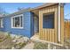 Inviting covered front porch with stylish wood siding and a welcoming entrance at 1701 W 50Th Ave, Denver, CO 80221