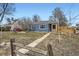 Charming blue home with a well-manicured lawn and inviting walkway at 1701 W 50Th Ave, Denver, CO 80221