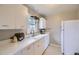 Functional kitchen featuring lots of counter space and an adjacent refrigerator at 1701 W 50Th Ave, Denver, CO 80221