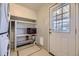 Convenient laundry room with shelving and a door to the outside at 1701 W 50Th Ave, Denver, CO 80221