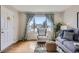 Inviting living room with hardwood floors, large window, and comfortable seating at 1701 W 50Th Ave, Denver, CO 80221