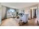Bright living room featuring hardwood floors, a large window with curtains, and neutral-toned furniture with stylish accents at 1701 W 50Th Ave, Denver, CO 80221