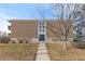 Brick apartment building entrance with a sidewalk leading to the door at 1606 Cottonwood Dr # 24S, Louisville, CO 80027