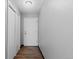 Hallway with wood floors, a front door, and a closet on the left at 1606 Cottonwood Dr # 24S, Louisville, CO 80027