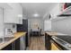 Open kitchen with stainless steel appliances, butcher block counters, and dining area at 1606 Cottonwood Dr # 24S, Louisville, CO 80027
