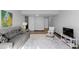 Open-concept layout with wood floors connecting the living area to a hallway at 1606 Cottonwood Dr # 24S, Louisville, CO 80027