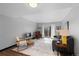 Bright living room with a gray sofa, wooden floors, and sliding glass doors to a balcony at 1606 Cottonwood Dr # 24S, Louisville, CO 80027