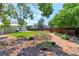 A charming backyard landscaped with decorative rock, mulch, mature trees, and perimeter fencing for privacy at 12935 Lake Circle Dr, Thornton, CO 80241