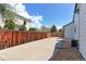 Spacious concrete patio with privacy fence, perfect for entertaining and outdoor activities in the backyard at 12935 Lake Circle Dr, Thornton, CO 80241