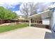 Spacious backyard featuring a covered patio, lush lawn, and beautiful landscaping at 12935 Lake Circle Dr, Thornton, CO 80241