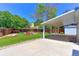 Covered backyard patio with a well-maintained lawn and garden area at 12935 Lake Circle Dr, Thornton, CO 80241