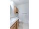 Clean bathroom with vanity, tiled shower, and matching wood cabinet at 12935 Lake Circle Dr, Thornton, CO 80241