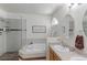 Serene bathroom featuring a soaking tub, seamless glass shower, and dual sink vanity at 12935 Lake Circle Dr, Thornton, CO 80241
