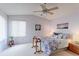 Bright bedroom features a ceiling fan, window, and a cozy floral-themed bed at 12935 Lake Circle Dr, Thornton, CO 80241
