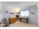 A functional bedroom with a window, wood dresser, and desk at 12935 Lake Circle Dr, Thornton, CO 80241