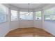 Bright breakfast nook with hardwood floors and large windows offering backyard views at 12935 Lake Circle Dr, Thornton, CO 80241