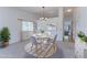 Cozy dining room with ample natural light, a modern chandelier, and seating for four at 12935 Lake Circle Dr, Thornton, CO 80241