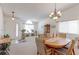 Neutral dining room with chandelier and a light wood table set and carpet at 12935 Lake Circle Dr, Thornton, CO 80241